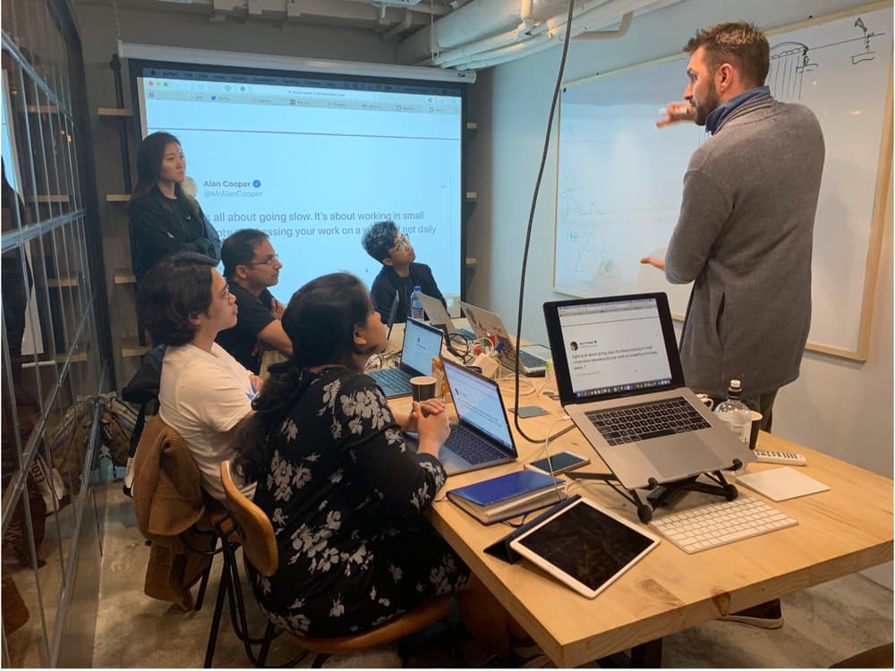 Ilya Belikin presenting to a diverse team